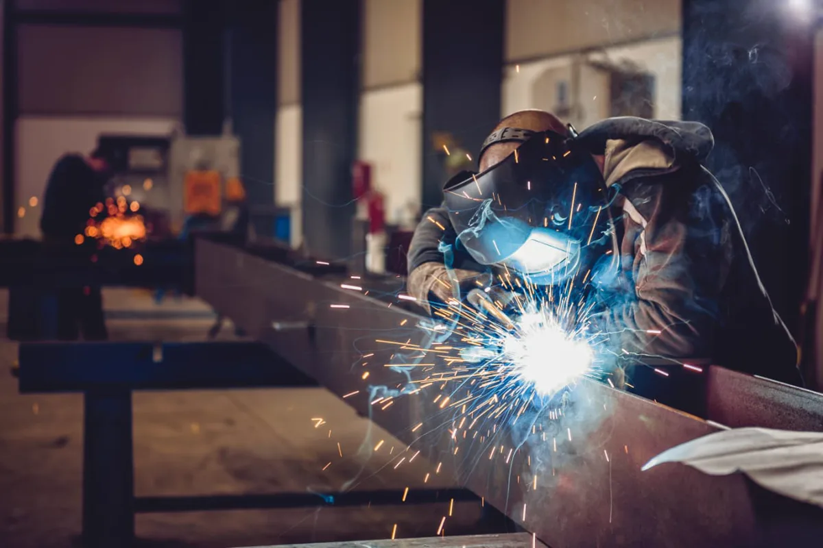 Welder working on a metal fabrication project